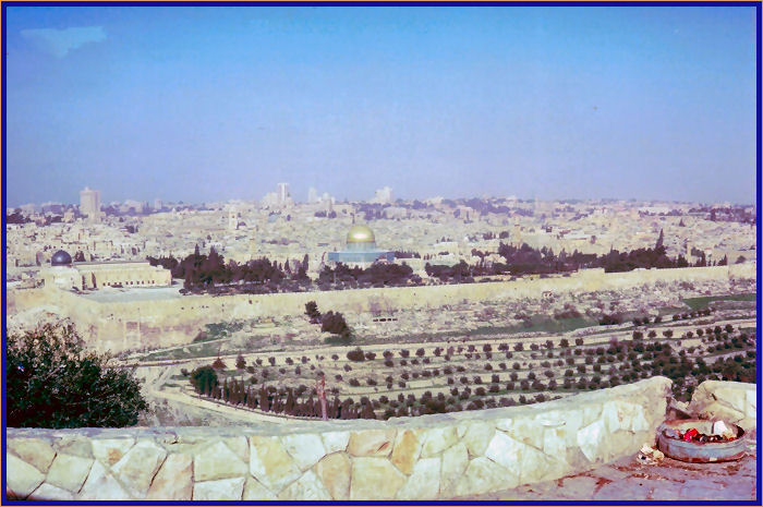 The Dome of the Rock is in the center and the black-domed Al-Aqsa mosque is to the left.
